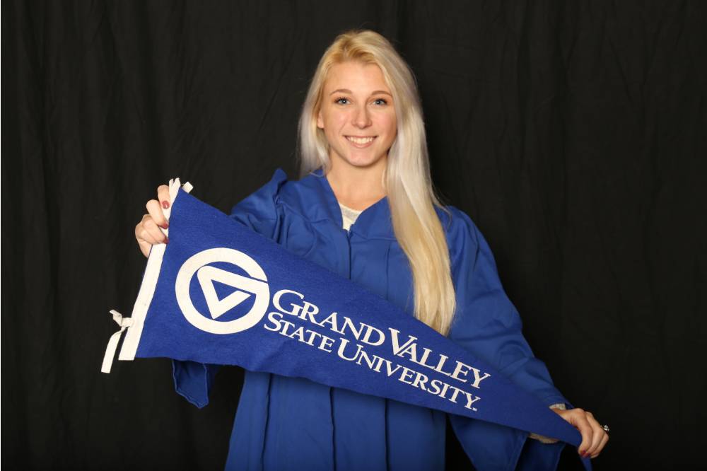 woman with grand valley flag at GradFest